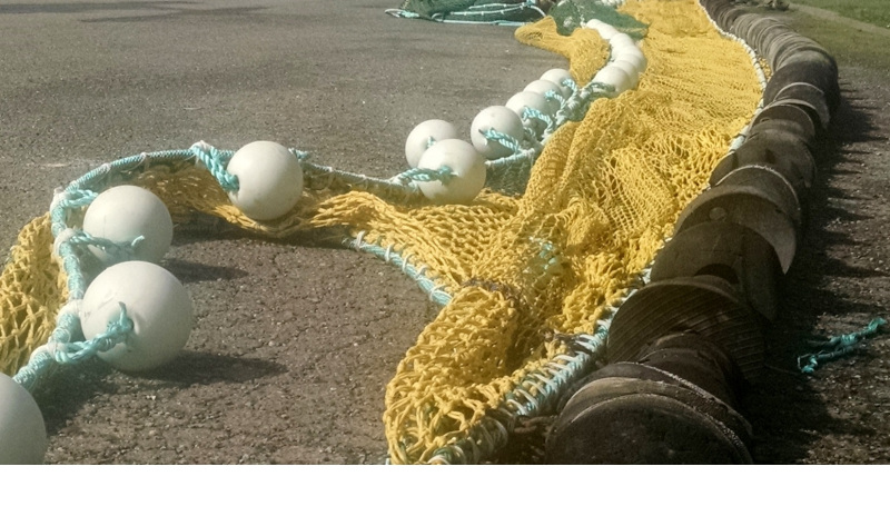 Fisherman assembling Trawler netting in Port Basin parking lot, across from Ocean Suites Motel, Lower Harbor Rd. Brookings, Oregon